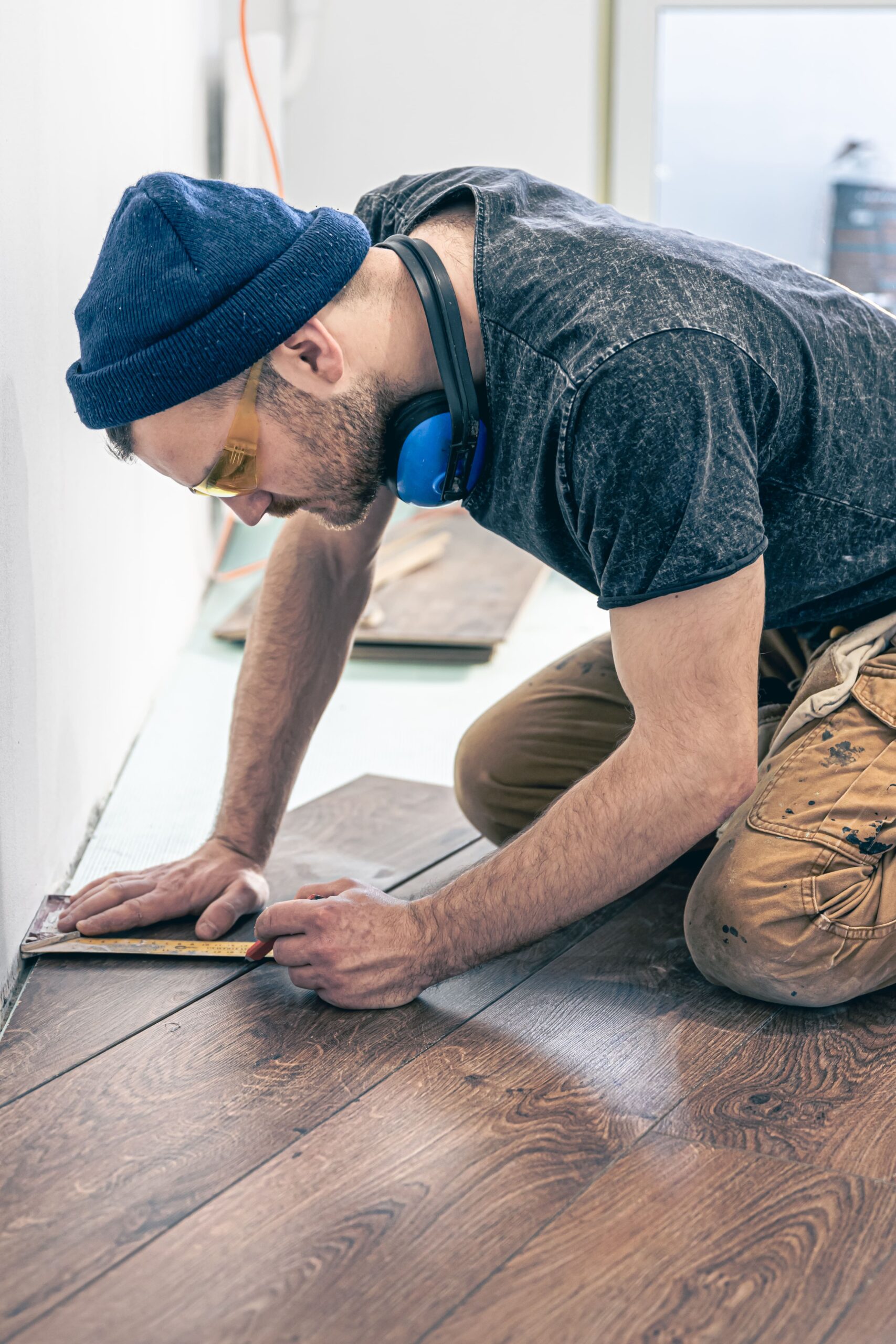 male-worker-puts-laminate-flooring-floor